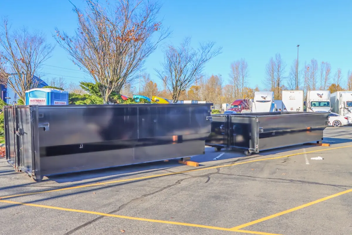 Professional dumpster rental service with roll-off container on residential driveway in Sanger